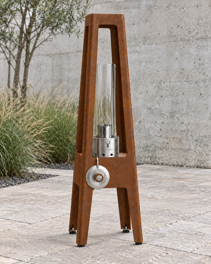 TORRE Corten bioethanol lamp with metal legs on an outdoor terrace in daylight.